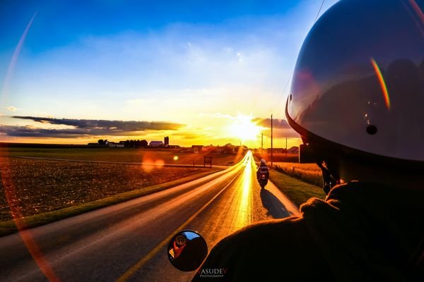 Person Riding Down Road On Motorcycle Heading Towards AI Checker Essay Convention