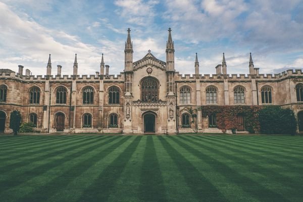 University Building Front Entrance With Beautifully Cut Green Grass Prepared for A Seminar on The AI Essay Checker