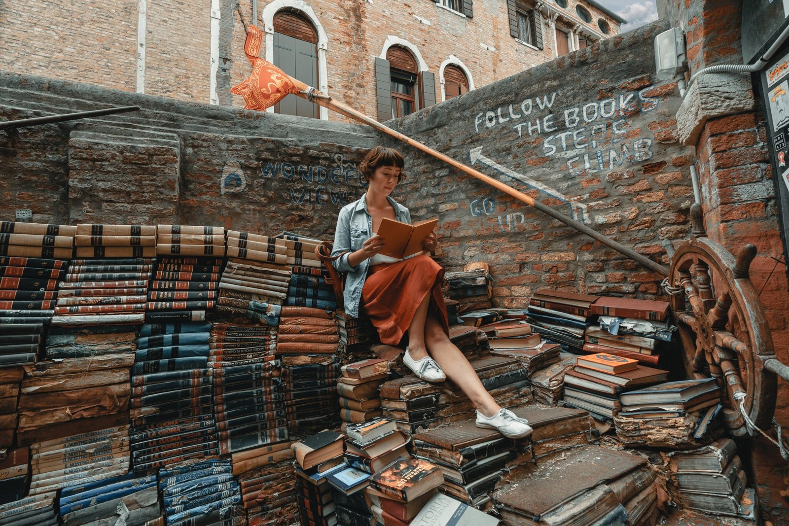 woman sitting in a pile of books - Free AI Source Finder for Essays