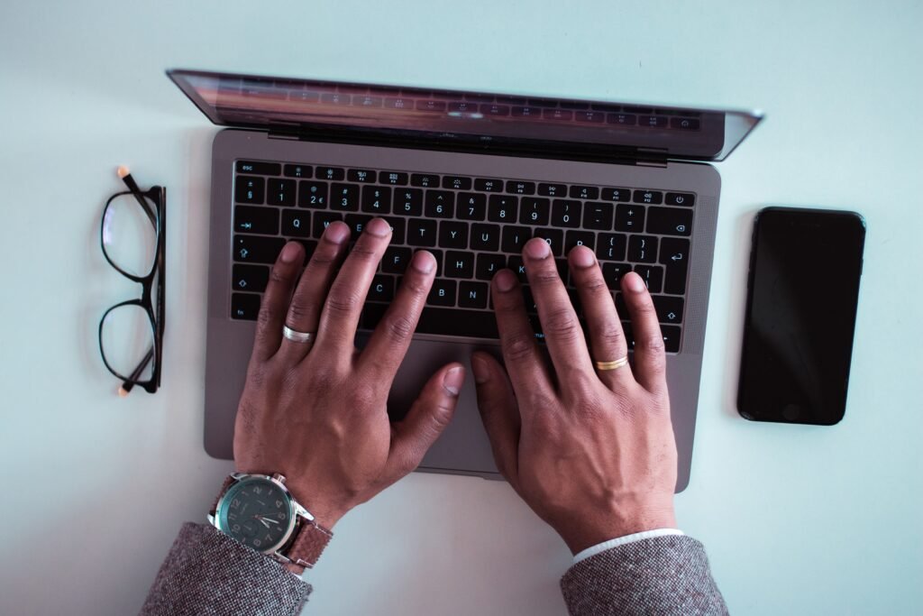 man typing in his next word document - best paraphrasing tool to beat turnitin