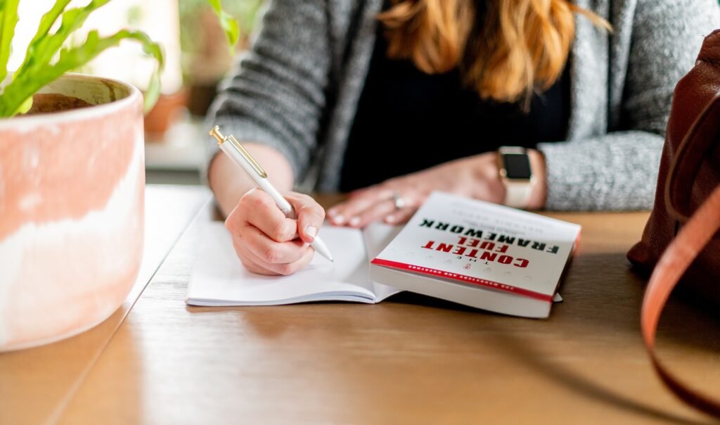 Woman making notes from a book - MLA auto citation