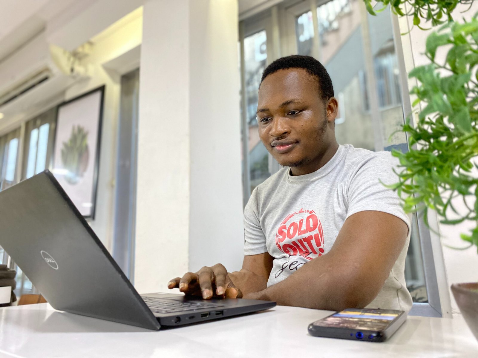 Student watching laptop and smiling - citation finder tool