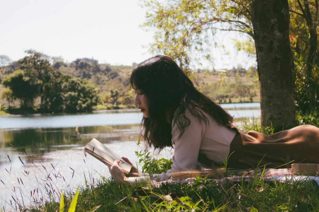 woman reading a book on leadership - unique argumentative essay topics