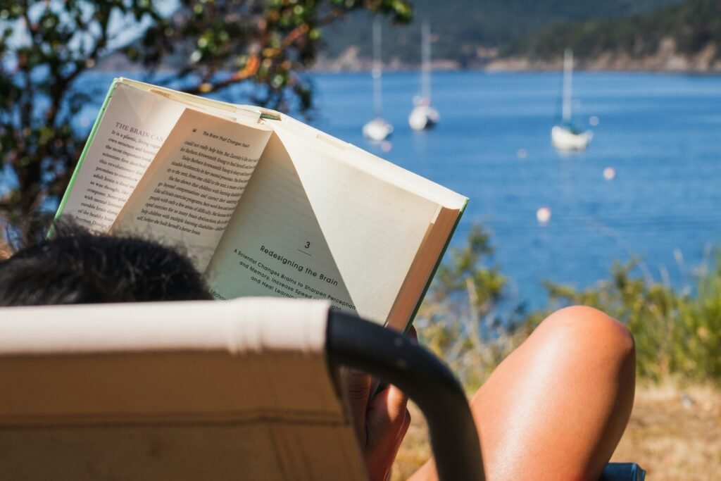 woman reading a hook line by the river - How to Write a Good Hook for an Essay