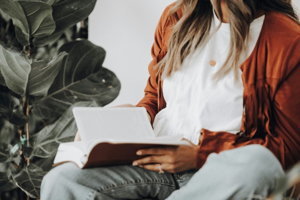 woman checking her notes on the book - How to Write a Good Hook for an Essay