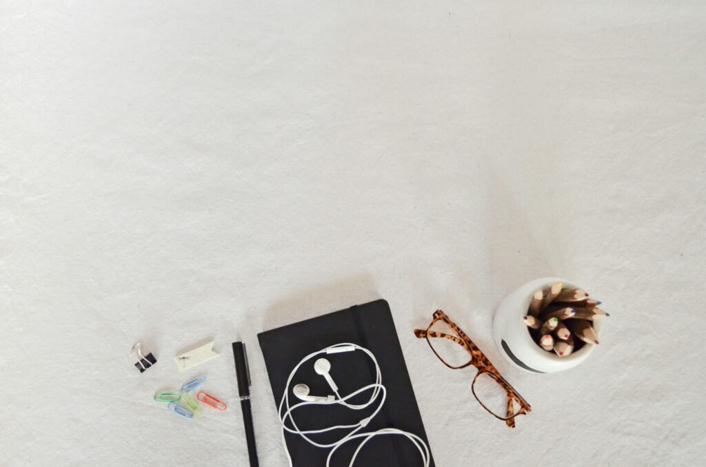 a desk with notebook and glasses - Scientifically Proven Study Methods