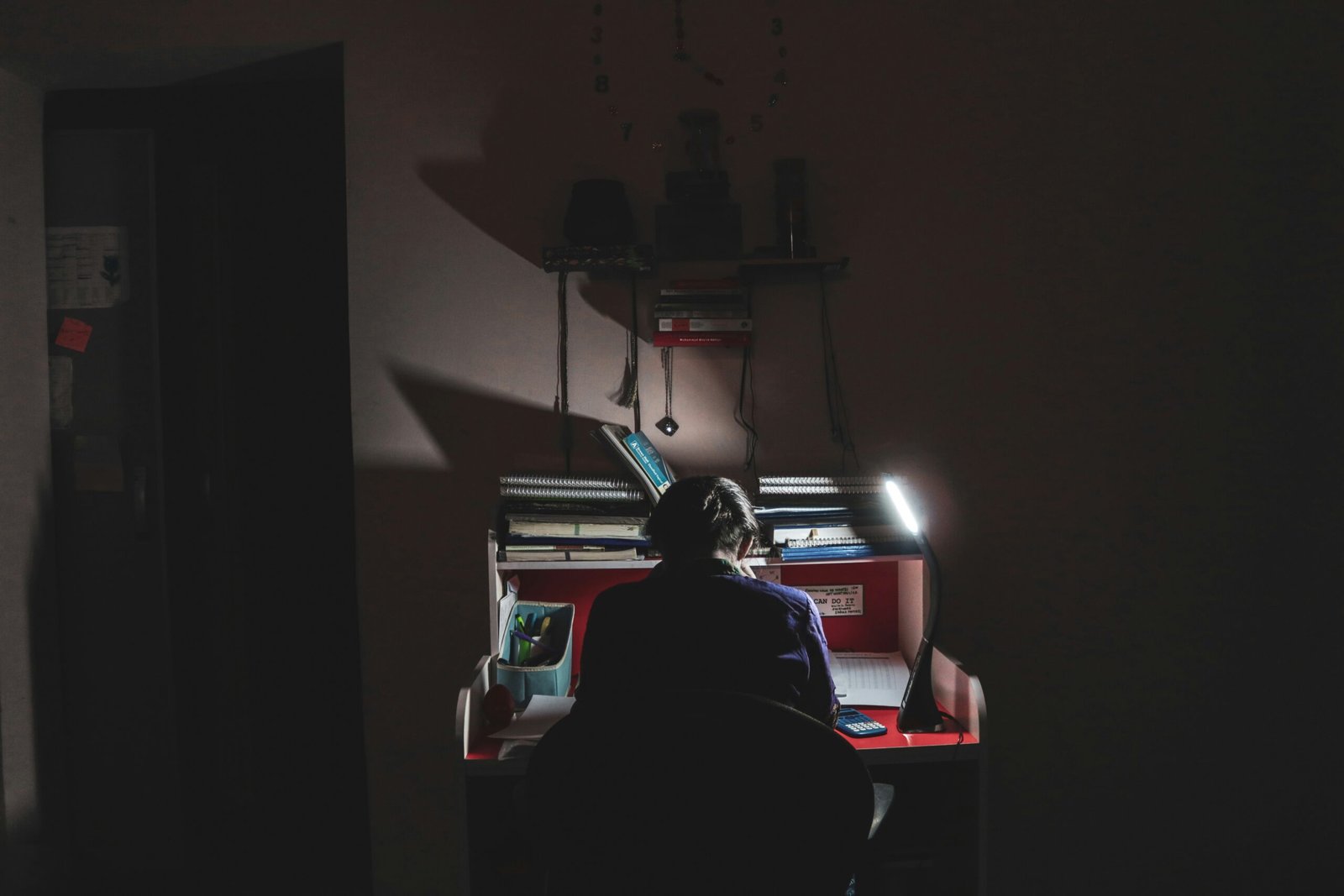 person studying in low light - How To Improve Study Habits