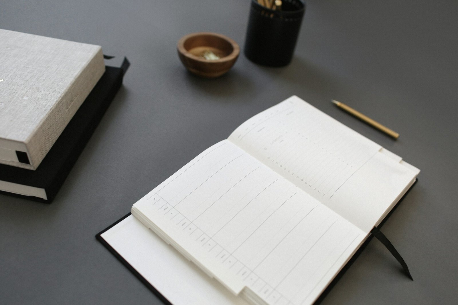 a desk with notebook - Active Study Methods