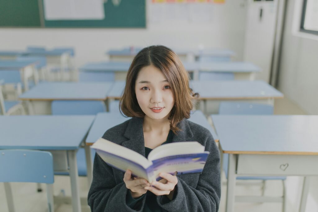 woman with a book in class - PSAT Vs SAT