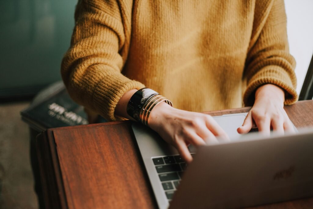 Person Writing something on Laptop Placed on Table - SAT Essay Tips