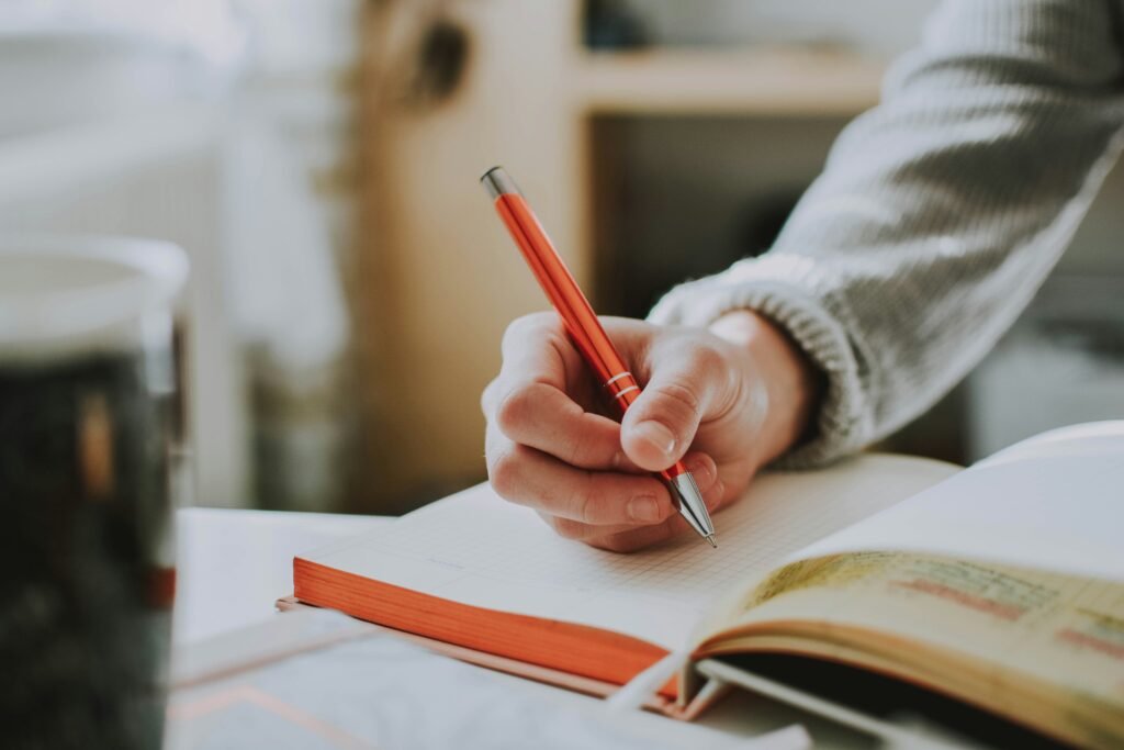 man writing on a copy - SAT Reading And Writing
