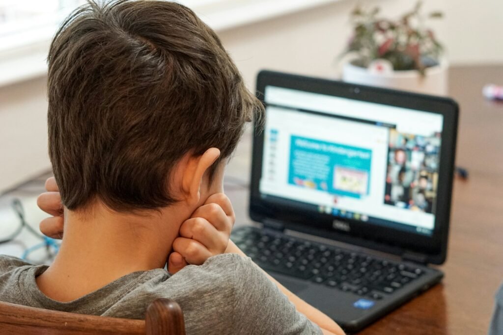 Boy Sitting in Front of Computer Thinking and Learning - Fiveable