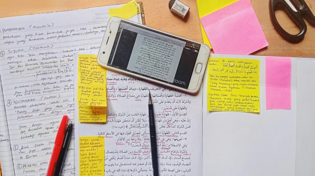 Mobile Phone Placed on Notebook along with Papers - SAT Essay Tips