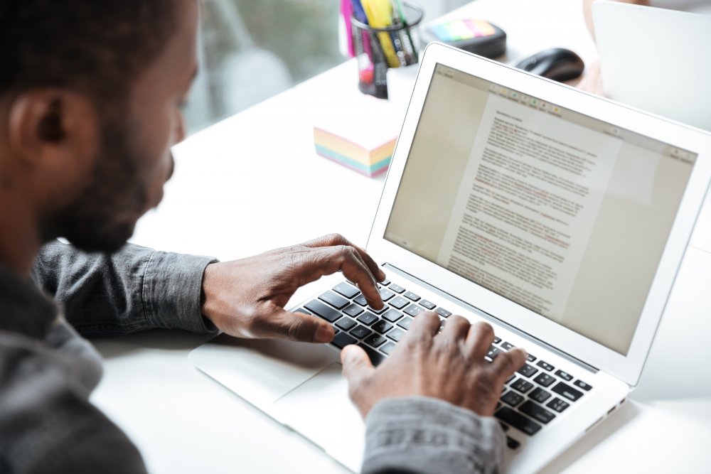 man typing on a laptop - Essay About Death