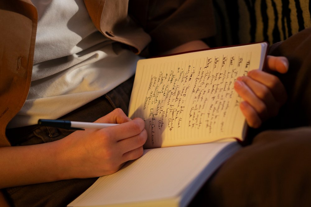 woman writing on a book - Is a Documentary a Primary Source