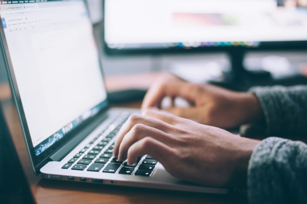 Person Working on Laptop - Essay About Bullying
