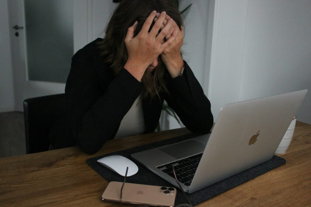 Depressed Person Working on Laptop - Essay About Bullying