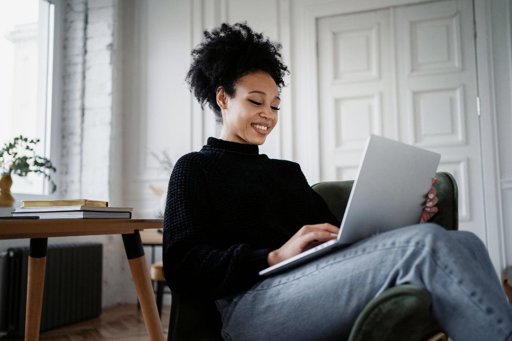 woman sitting on a chair and using a laptop - Social Media Argumentative Essay Topics		
