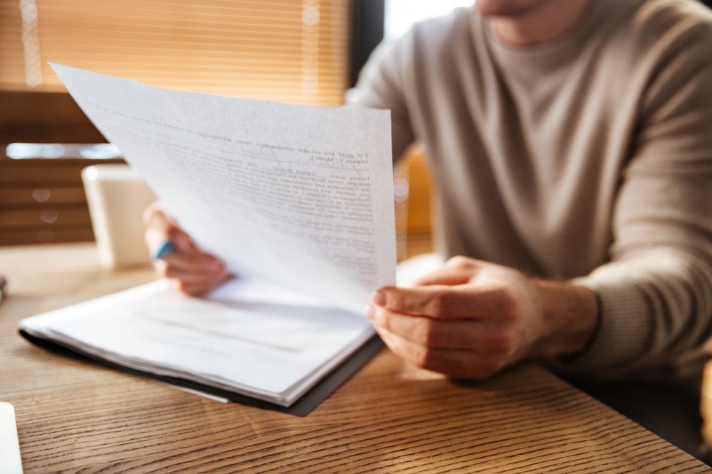 man holding a paper - Diversity Essay Examples