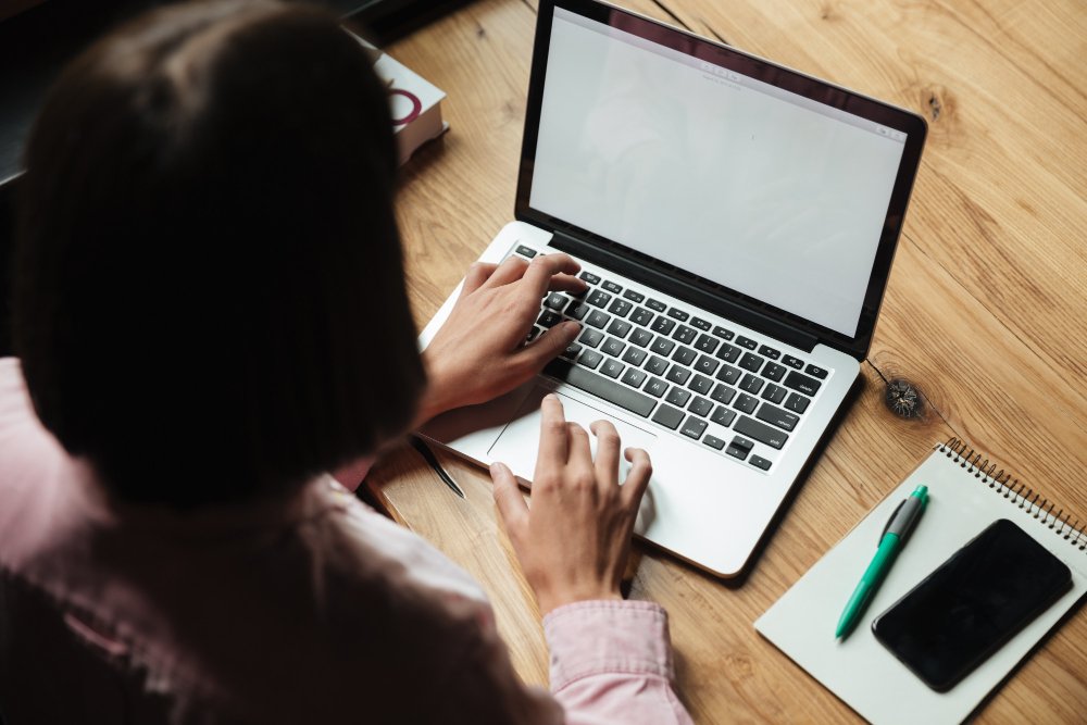 woman typing on a laptop - Social Media Argumentative Essay Topics		

